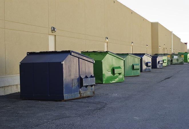 several large trash cans setup for proper construction site cleanup in Brighton